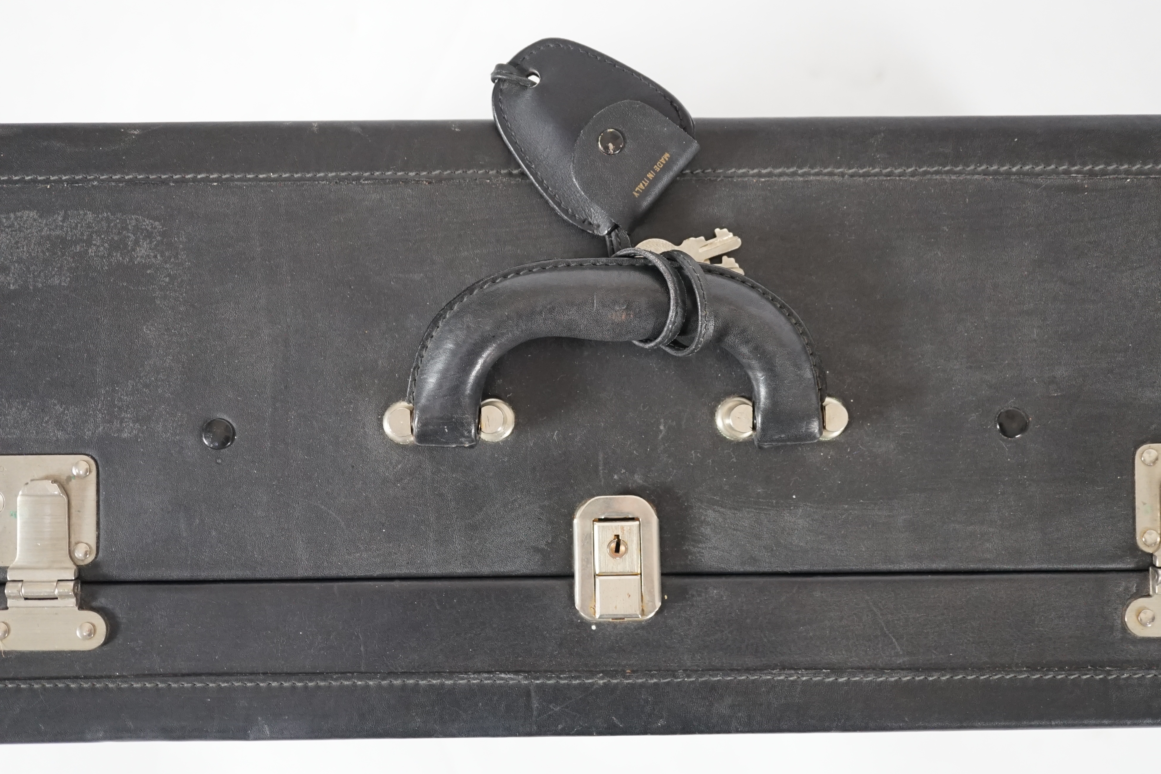 A Nina Cerruti black leather suitcase Length 64.5cm, depth 22cm, width 42cm